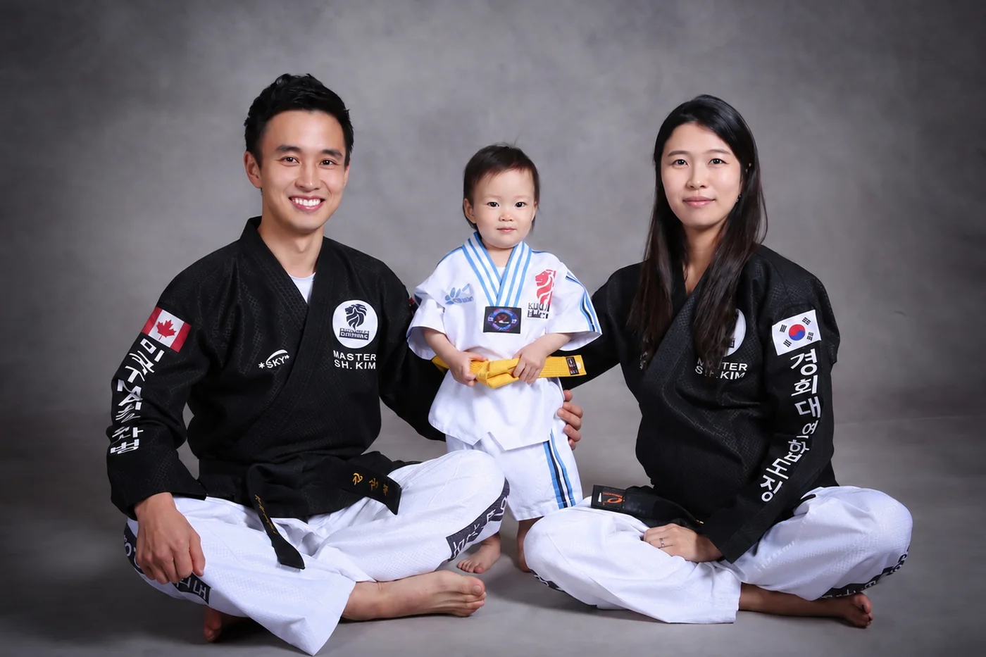 Master Sanghee Kim with his wife and their child, all in doboks