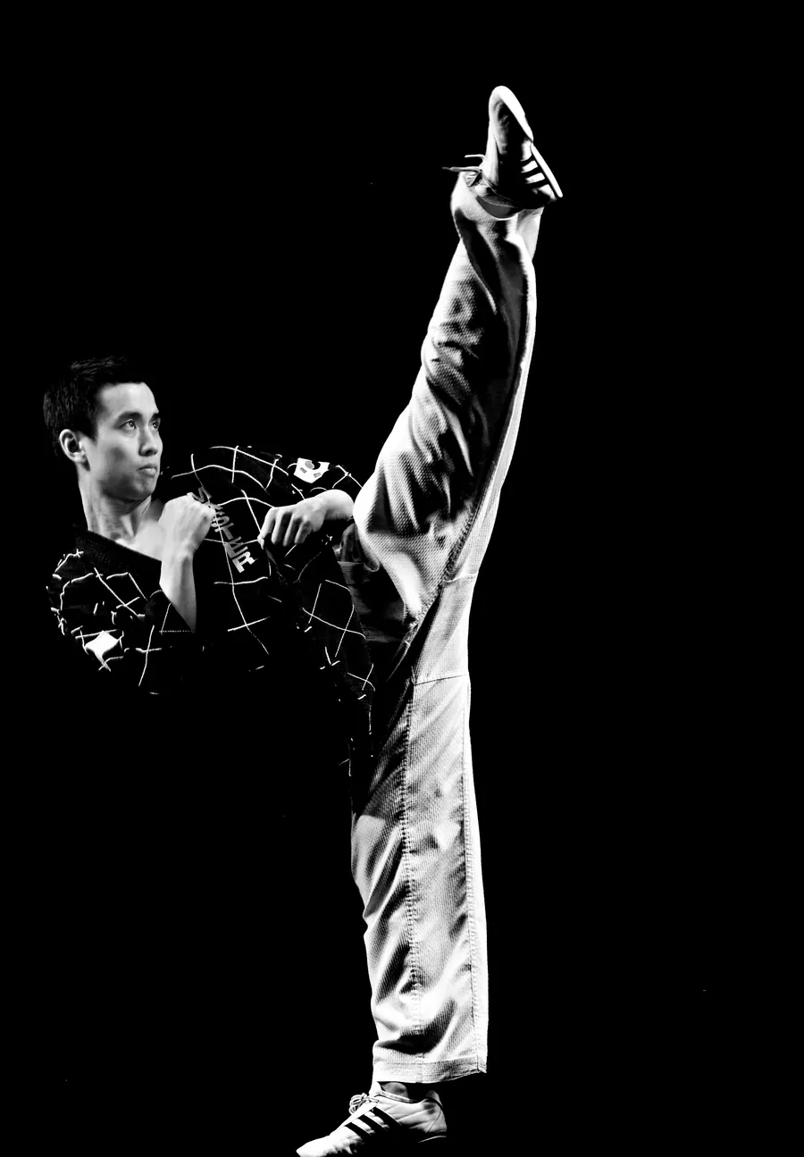 Master Sanghee Kim performing a high kick
